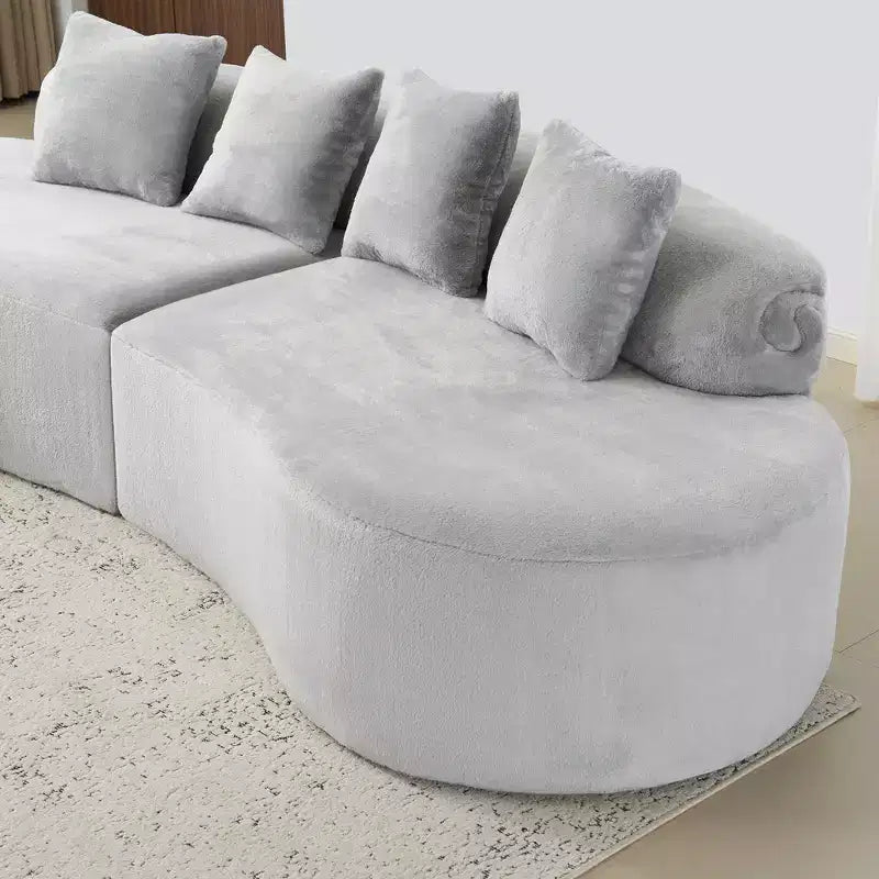 Canapé en flanelle courbé, moderne et simple. Multicolore créatif pour le salon, avec une combinaison de coussins.