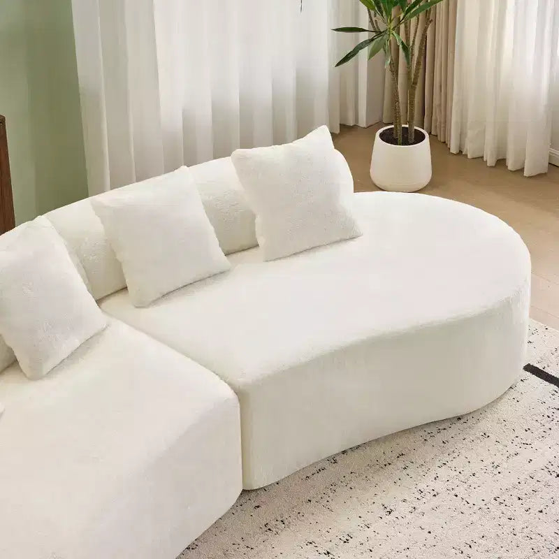 Canapé en flanelle courbé, moderne et simple. Multicolore créatif pour le salon, avec une combinaison de coussins.